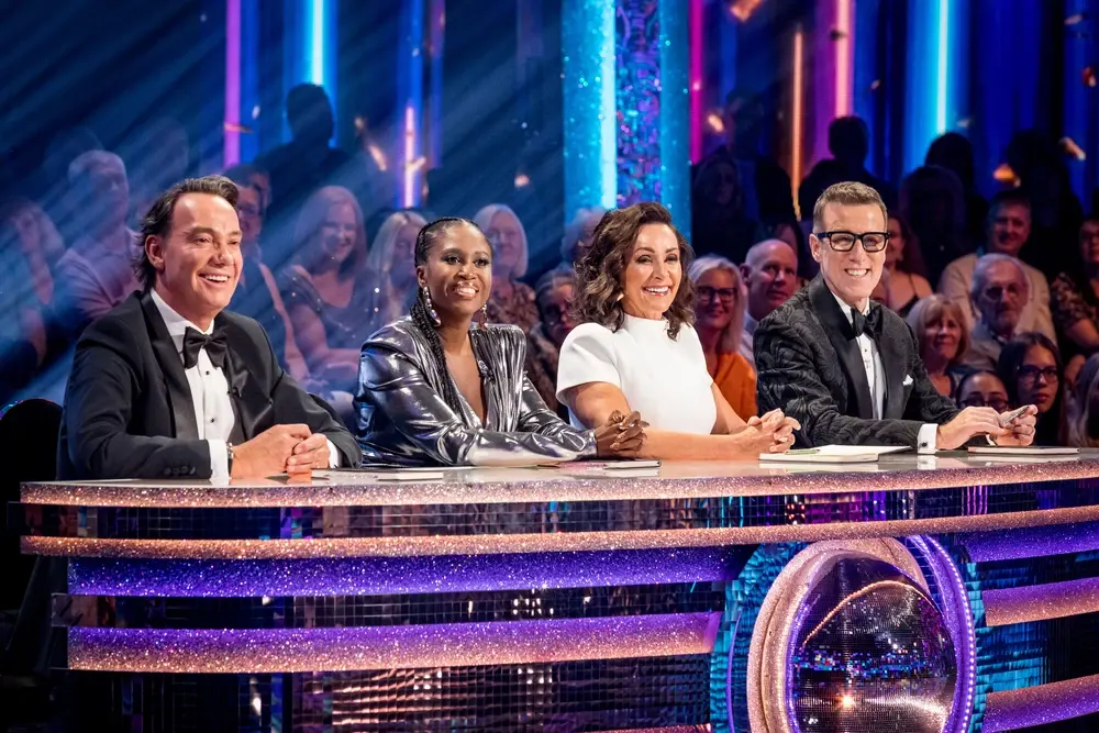 strictly judges behind their desk. Credit: BBC/Guy Levy